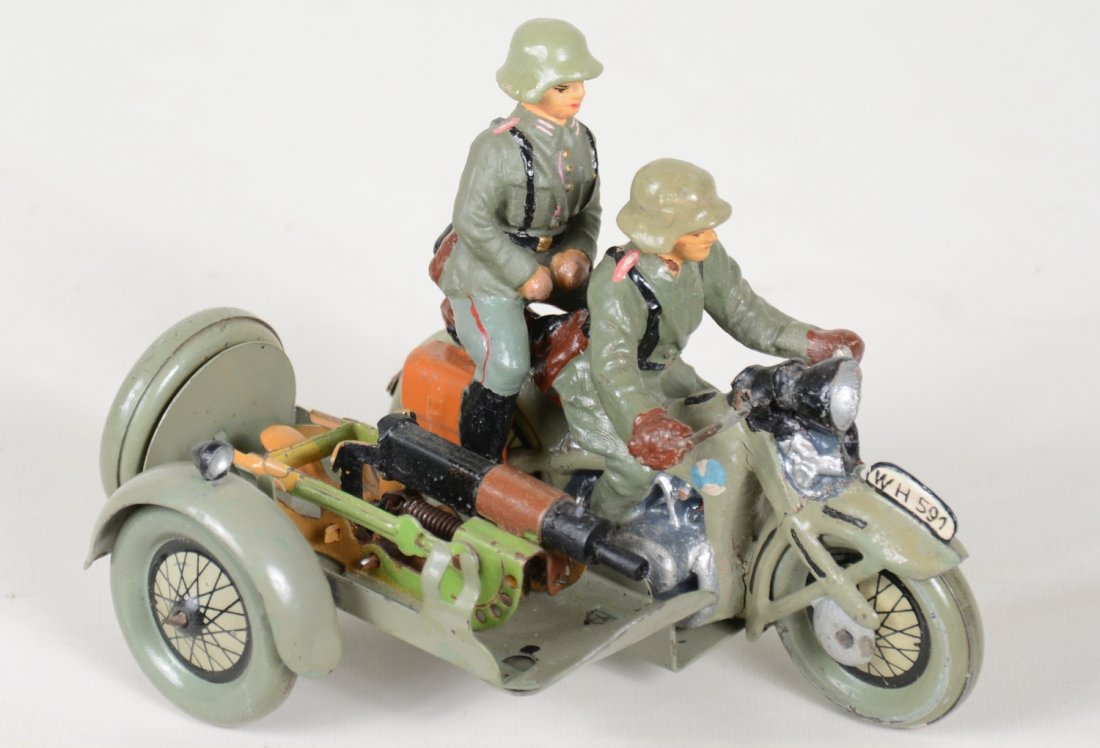 Scarce Tipp German Motorcycle Machine Gun Crew: Made for Lineol. Tin litho and composition motorcycle with sidecar. 1 soldier is removable and tin machine gun has an operating breach. It is in great shape, showing light playwear, C8. Super example!