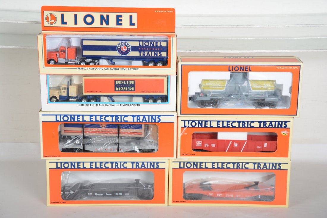 O Ga. Lionel Freight Cars: Includes 52099 & 52040 flats with tractor trailers; 16924 trailer flat; 19615 Vulcan tank; 16943 JC gondola. All appear like new with boxes, C9-10