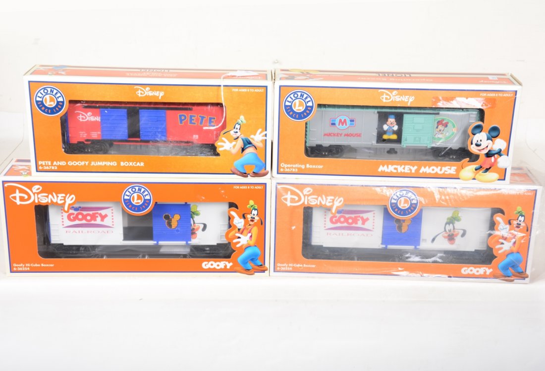 4 Lionel Disney Freight Cars: Includes 36254 Goofy hi-cubes; 36782 Pete & Goofy jumping boxcar; 36783 Mickey Mouse operating boxcar. These are old store stock, C10