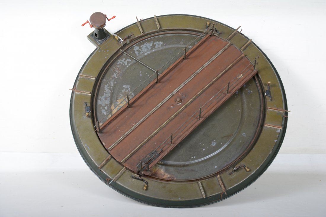 Scarce Large Bing Turntable: 1 Gauge 2-rail. 56cm wide. 3-position with brass handle locks at each end of the stop. Functions intermittently as gears skip a bit, but mechanism is complete. It shows minor touch-up and some flaking