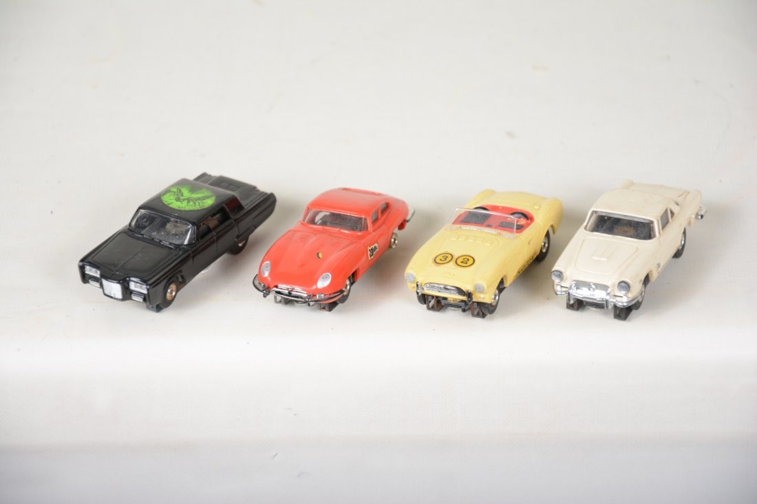 4 Aurora T-Jet HO Slot Cars: Includes a nice Green Hornet Black beauty, C9; Masaratti, C8; Corvette missing driver, some decals; Jag X type. Some missing rubber tires, bodies appear intact and otherwise clean.