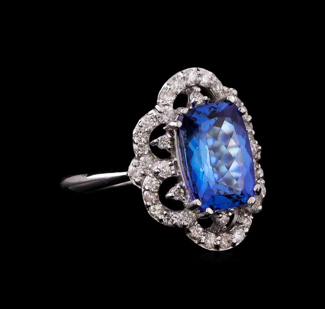 14KT White Gold 3.20 ctw Tanzanite and Diamond Ring: One electronically tested 14KT white gold ladies cast tanzanite and diamond ring with a bright polish finish. Identified with markings of "K14". Condition is new. Containing: One prong set rectangular