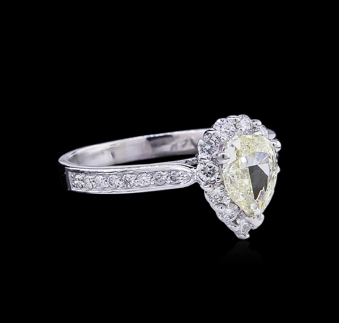 1.45 ctw Fancy Light Yellow Diamond Ring - 14KT White: One electronically tested 14KT white gold lady's cast wedding ring with a basket halo with a bright polish finish. The featured lady's ring has a shank measuring 2.13 millimeters wide. Identified with