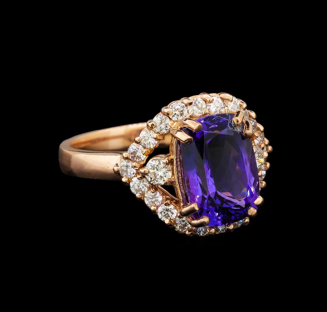 14KT Rose Gold 3.30 ctw Tanzanite and Diamond Ring: One electronically tested 14KT rose gold ladies cast tanzanite and diamond ring with a bright polish finish. Identified with markings of "K14". Condition is new. Containing: One prong set oval modifie