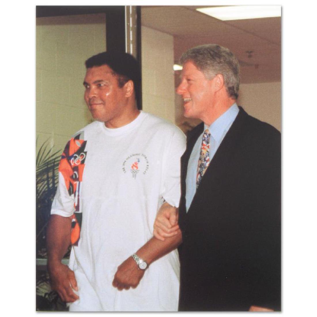 Muhammad Ali with Bill Clinton (walking) by Ali,: Own a piece of sports history with this Muhammad Ali and Bill Clinton photo. Taken at the peak of his fame as one of the greatest heavyweight championship boxers of all time, this photo is sure to com