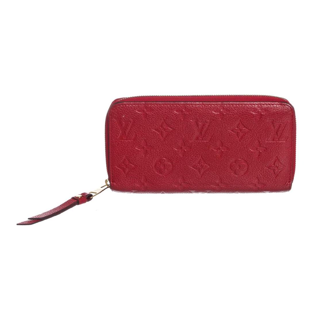 Louis Vuitton Red Empriente Leather Monogram Zippy: Red monogram Empreinte leather Louis Vuitton Zippy wallet with gold-tone hardware, tonal leather lining, dual bill compartments, interior zipper pocket and slit pocket, twelve card slots and zip-aroun