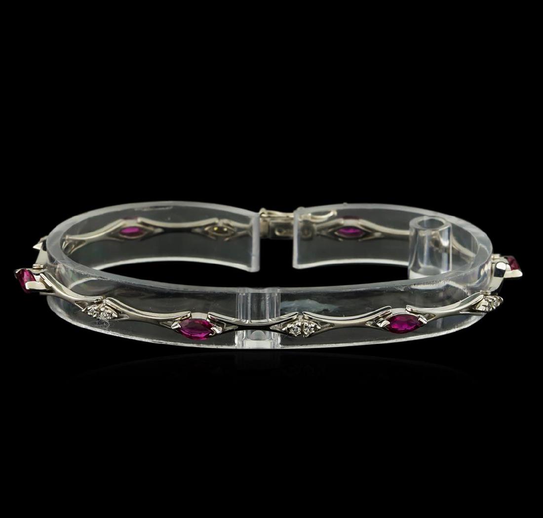 0.60 ctw Ruby and Diamond Bracelet - 14KT White Gold: One bracelet featuring: 14KT white gold weighing approximately 8.74 grams containing rubies with a total weight of 0.6ct and diamonds with a total weight of 0.13ct.