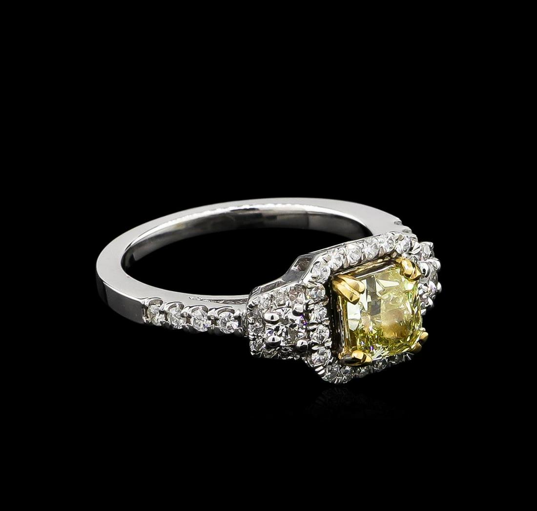 1.56 ctw Fancy Light Yellow Diamond Ring - 14KT White: One electronically tested 14KT white gold lady's cast wedding ring with a cathedral shank with a bright polish finish. The featured lady's ring has a shank measuring 1.71 millimeters wide. Identified 