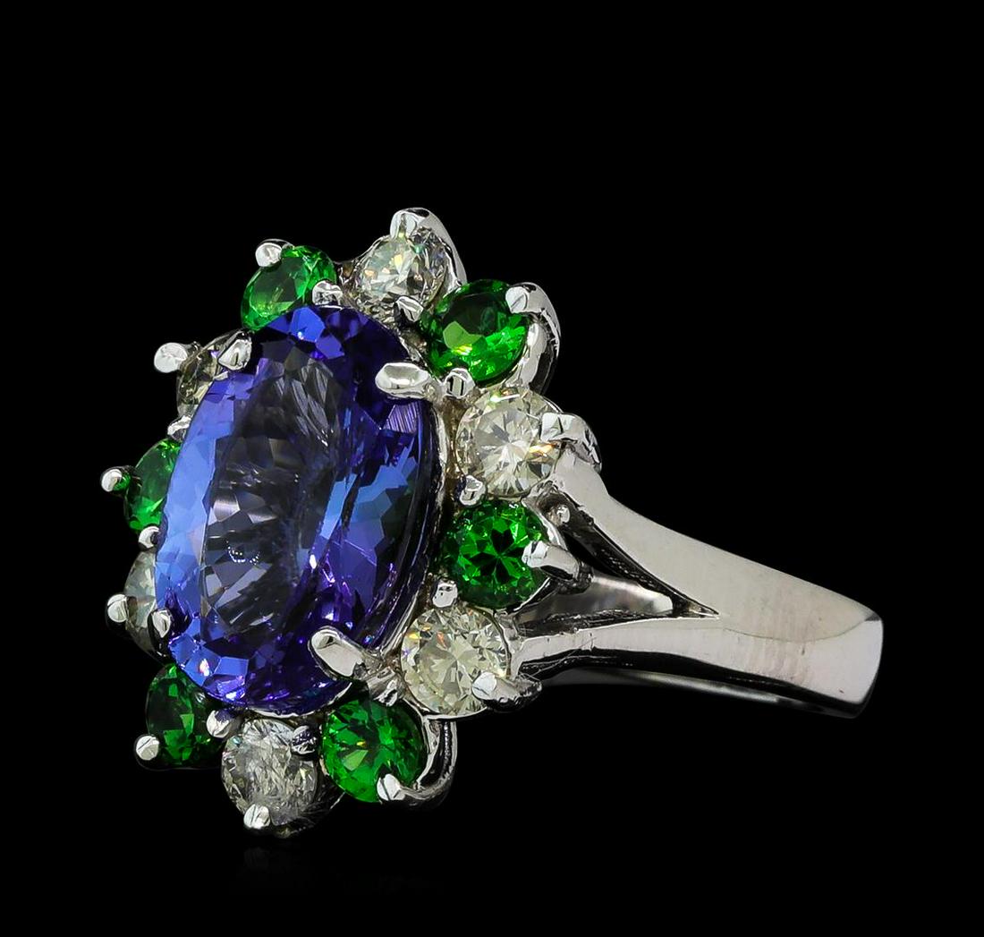 3.90 ctw Tanzanite, Tsavorite and Diamond Ring - 14KT: One electronically tested 14KT white gold lady's cast fashion ring with a basket halo with a bright polish finish. The featured lady's ring has a shank measuring 2.83 millimeters wide. Identified with