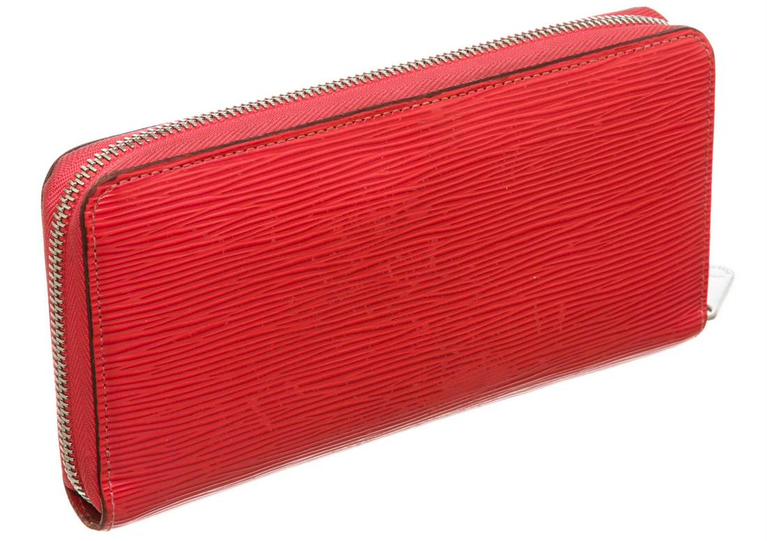 Louis Vuitton Red Epi Leather Monogram Zippy Wallet: Red Epi leather Louis Vuitton Zippy wallet with silver-tone hardware, tonal leather interior, five compartments; one with zip closure, dual bill compartments, eight card slots and zip-around closure a