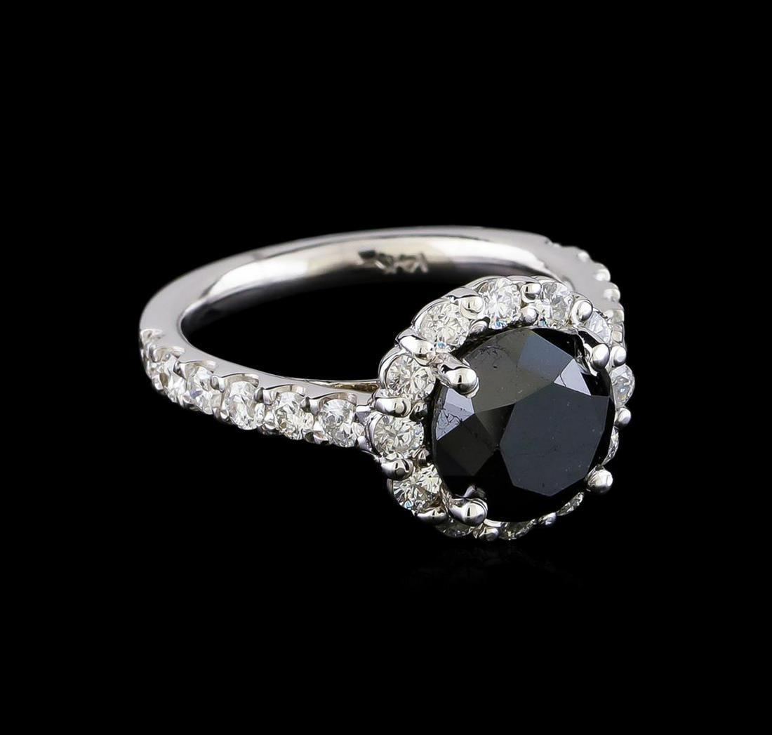 4.78 ctw Black Diamond Ring - 14KT White Gold: One electronically tested 14KT white gold lady's cast fashion ring with a straight line basket halo with a bright polish finish. The featured lady's ring has a shank measuring 2.36 millimeters in widt
