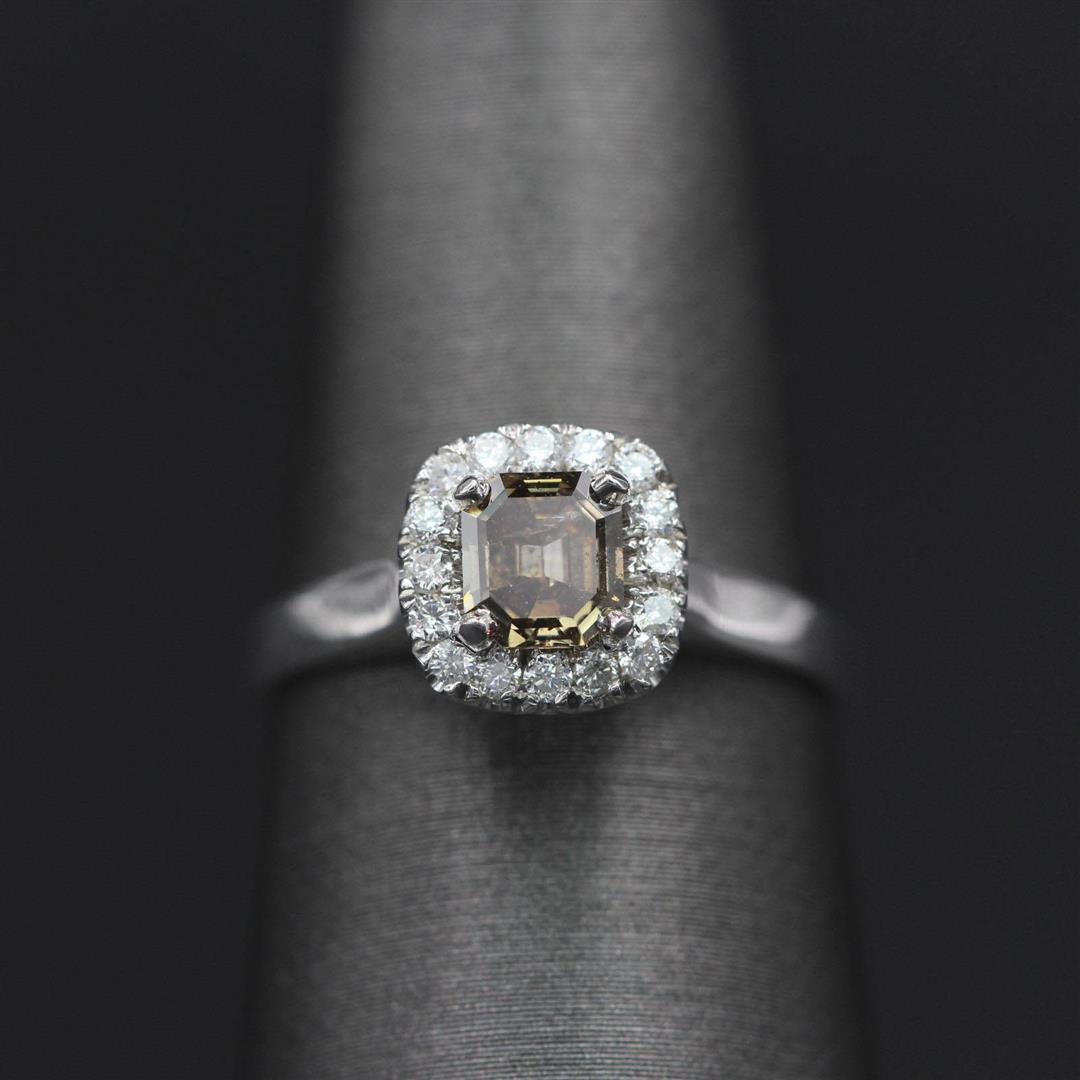 0.80 ctw Diamond Ring - 14KT White Gold: One lady's wedding ring featuring: 14KT white gold weighing 2.85 grams containing one center diamond weighing 0.59ct and side diamonds weighing 0.21ctw. The center diamond is round brilliant cut with 