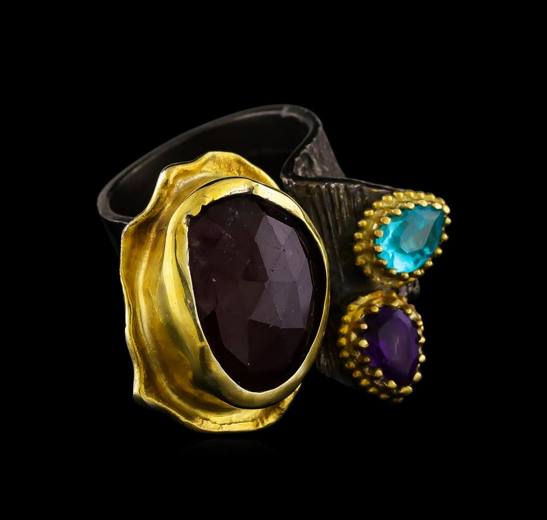 Sterling Silver Ring: One of a kind high fashion sterling silver Ring weighing 22 grams. Black Antique texture. Containing: Ruby, Amethyst, Cyan Crystal. This sterling silver promises a lasting shine.