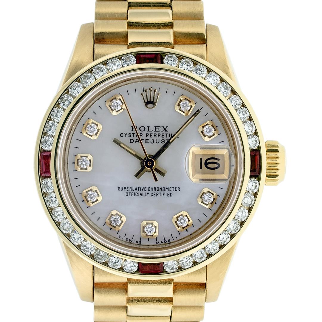 Rolex Ladies 18K Yellow Gold MOP Diamond & Ruby: One Ladies 18K Yellow Gold Rolex President Polished, Serviced & Electronically Tested, Yellow Gold Case: 26mm, 18K Yellow Gold Crown, Custom Bezel: New 18K Yellow Gold Ruby Channel Set Diamond Bezel, 