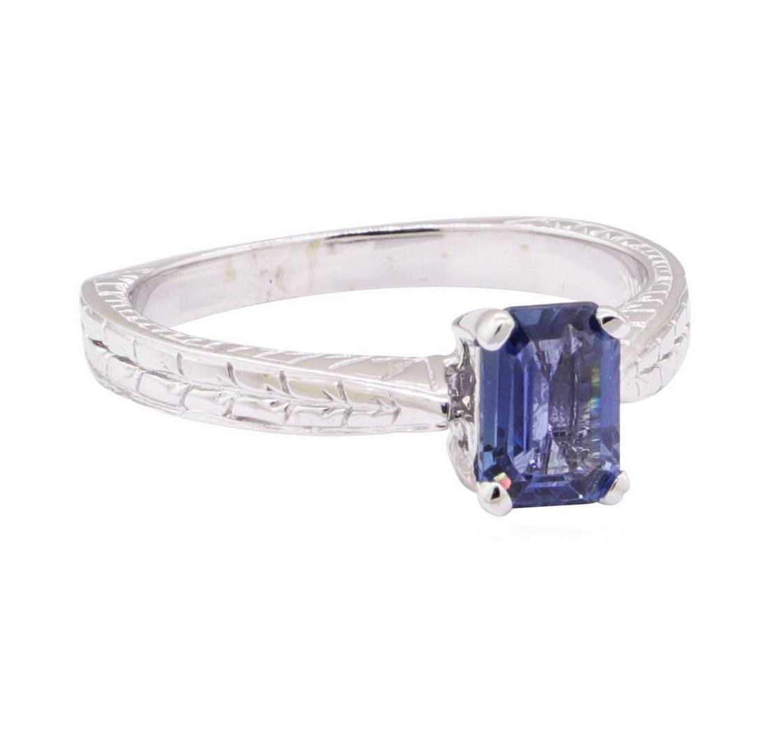 1.09 ctw Blue Sapphire Solitaire Ring - 14KT White Gold: One ring featuring: 14KT white gold weighing 3.9 grams containing one emerald cut blue sapphire weighing 1.09ct. The featured ring is a pinched solitaire ring with a European shank with vintage style 