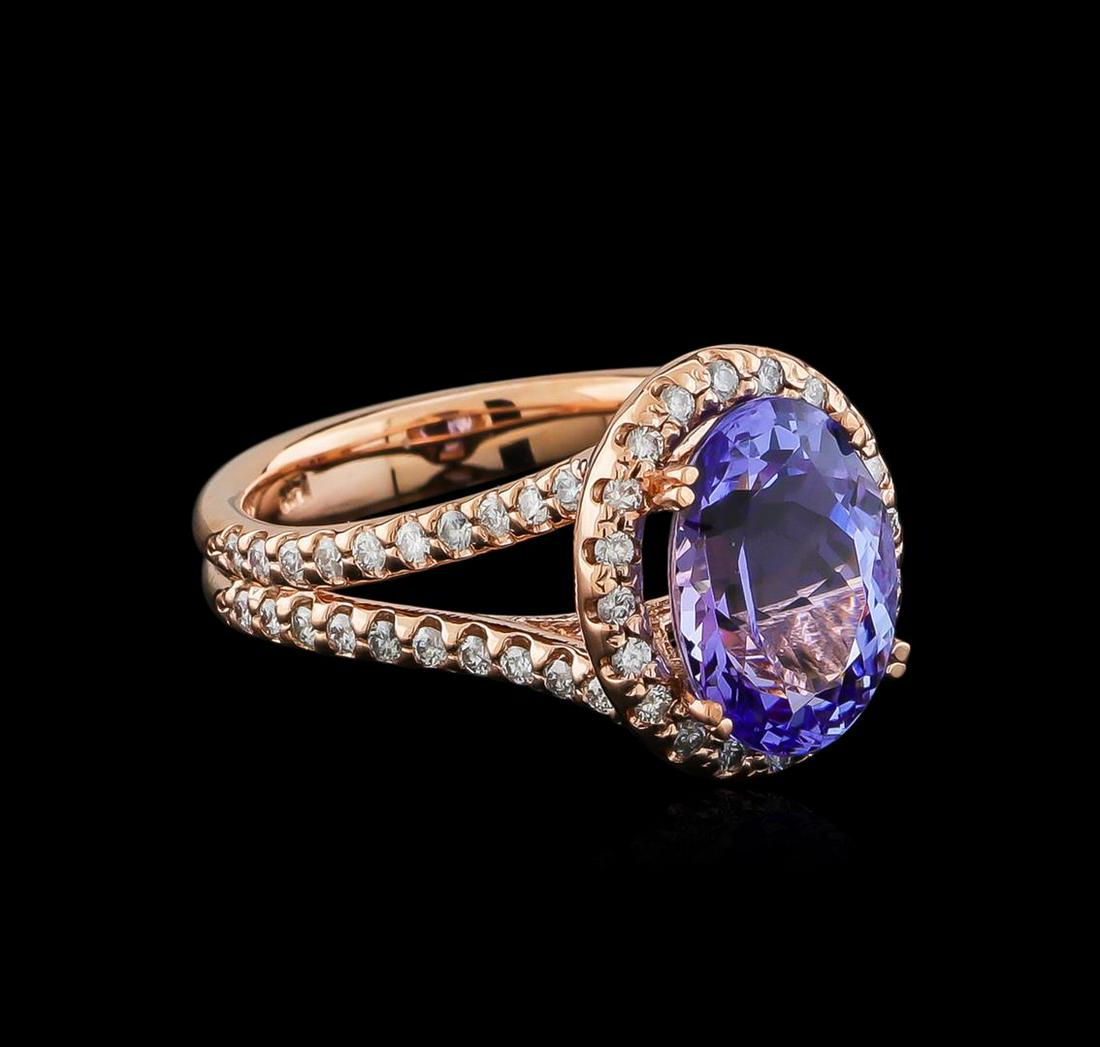 4.01 ctw Tanzanite and Diamond Ring - 14KT Rose Gold: One electronically tested 14KT rose gold lady's cast fashion ring with a split shank halo with a bright polish finish. The featured lady's ring has a shank measuring 3.88 millimeters wide. Identified 