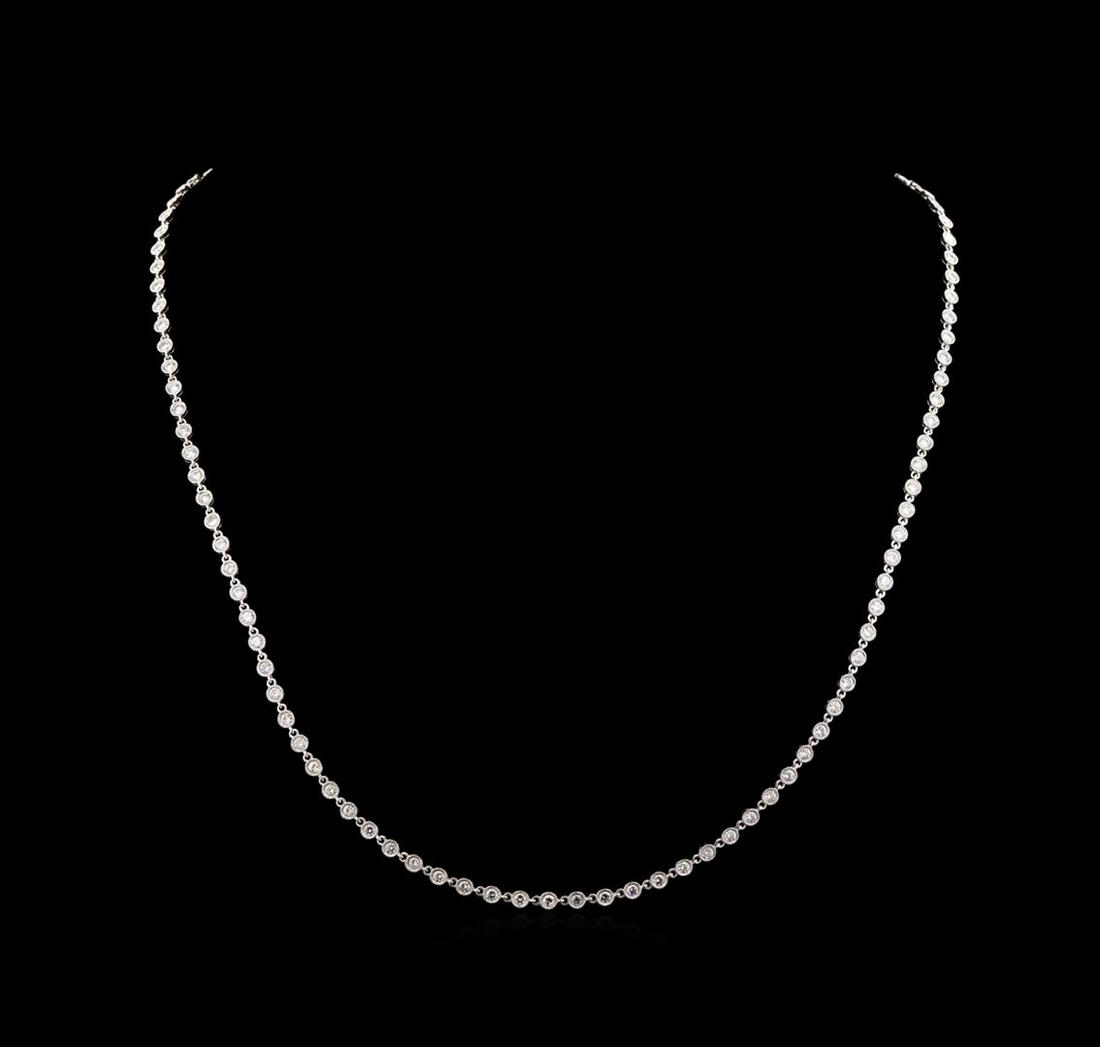 7.01 ctw Diamond Necklace - 18KT White Gold: One electronically tested 18KT white gold lady's combination cast & assembled diamonds by the yard necklace with a concealed clasp with a bright polish with milgrain detailing finish. The featured lad
