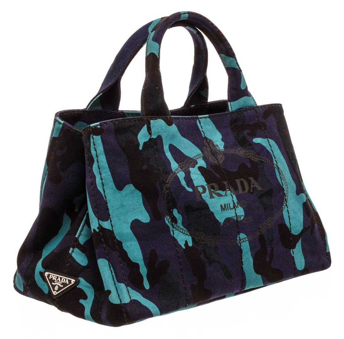 Prada Blue Purple Camo Canvas Medium Canapa Shopping: One Prada Blue Purple Camo Canvas Medium Canapa Shopping Tote Bag. Blue and purple camouflage Canapa Prada ping tote with silver-tone hardware, dual rolled top handles, logo print at front, protective