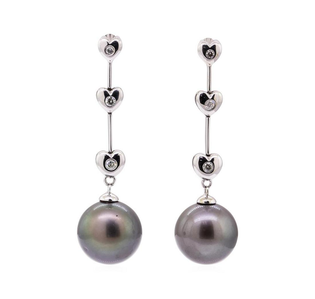 0.15 ctw Diamond and Tahitian Pearl Dangle Earrings -: One pair of dangle earrings featuring: 14KT white gold weighing 7.2 grams containing diamonds weighing 0.15ctw and two black Tahitian pearls measuring 11.5mm in diameter. The diamonds are set in heart