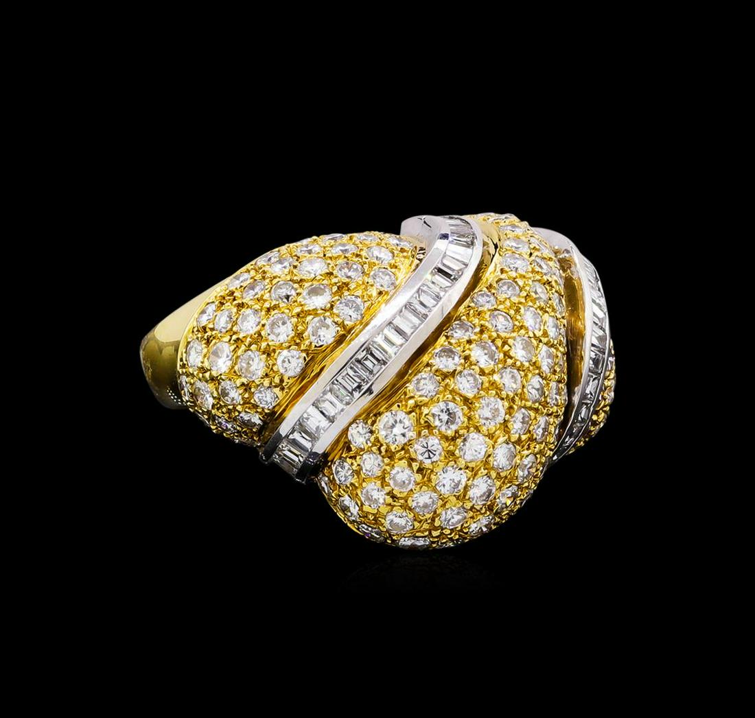 5.40 ctw Diamond Ring - 18KT Yellow Gold: One electronically tested 18KT yellow gold ladies cast diamond ring. The ring features three diamond curvatures with baguette diamond ribbon accents supported by tapering shoulders, completed by a fou
