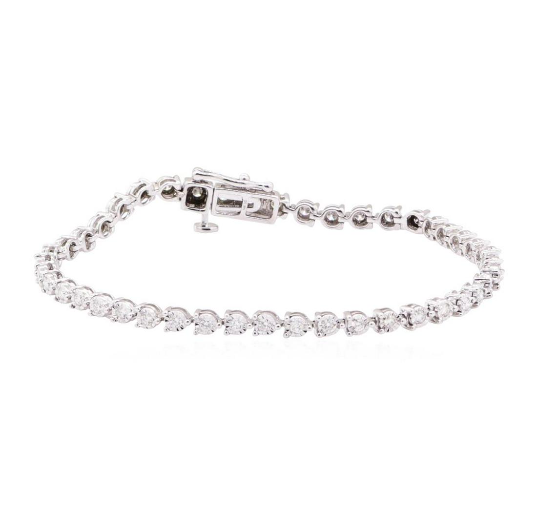 0.60 ctw Diamond Tennis Bracelet - 14KT White Gold: One tennis bracelet featuring: 14KT white gold weighing 6.3 grams containing diamonds weighing 0.60ctw. The bracelet measures approximately six and a half inches in length.