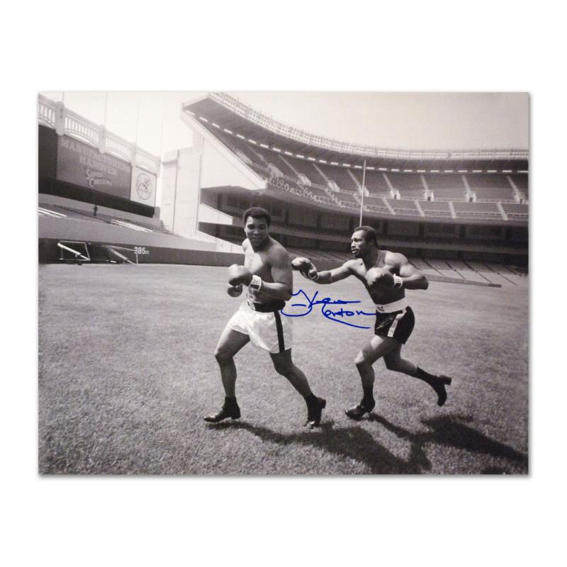 Ken Norton Chasing Ali by Norton & Ali: Perfect for any boxing enthusiast, "Ken Norton and Ali, Yankee Stadium" commemorates the world-famous boxing matches between Ken Norton and Muhammad Ali. This photograph is hand-autographed by multi-t