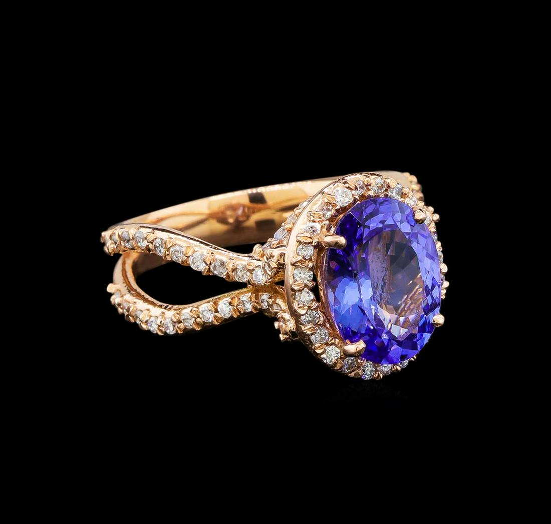 14KT Rose Gold 4.34 ctw Tanzanite and Diamond Ring: One electronically tested 14KT rose gold ladies cast tanzanite and diamond ring with a bright polish finish. Identified with markings of "14K". Condition is new. Containing: One prong set oval oval mo