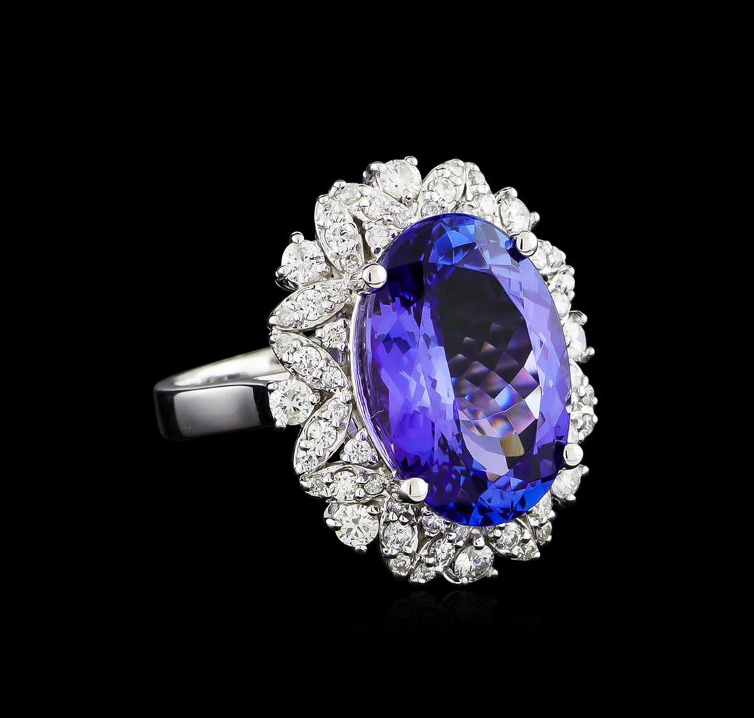 10.00 ctw Tanzanite and Diamond Ring - 14KT White Gold: One electronically tested 14KT white gold ladies cast tanzanite and diamond ring with a bright polish finish. The featured tanzanite is set within a stylized diamond floret supported by a ribbed under