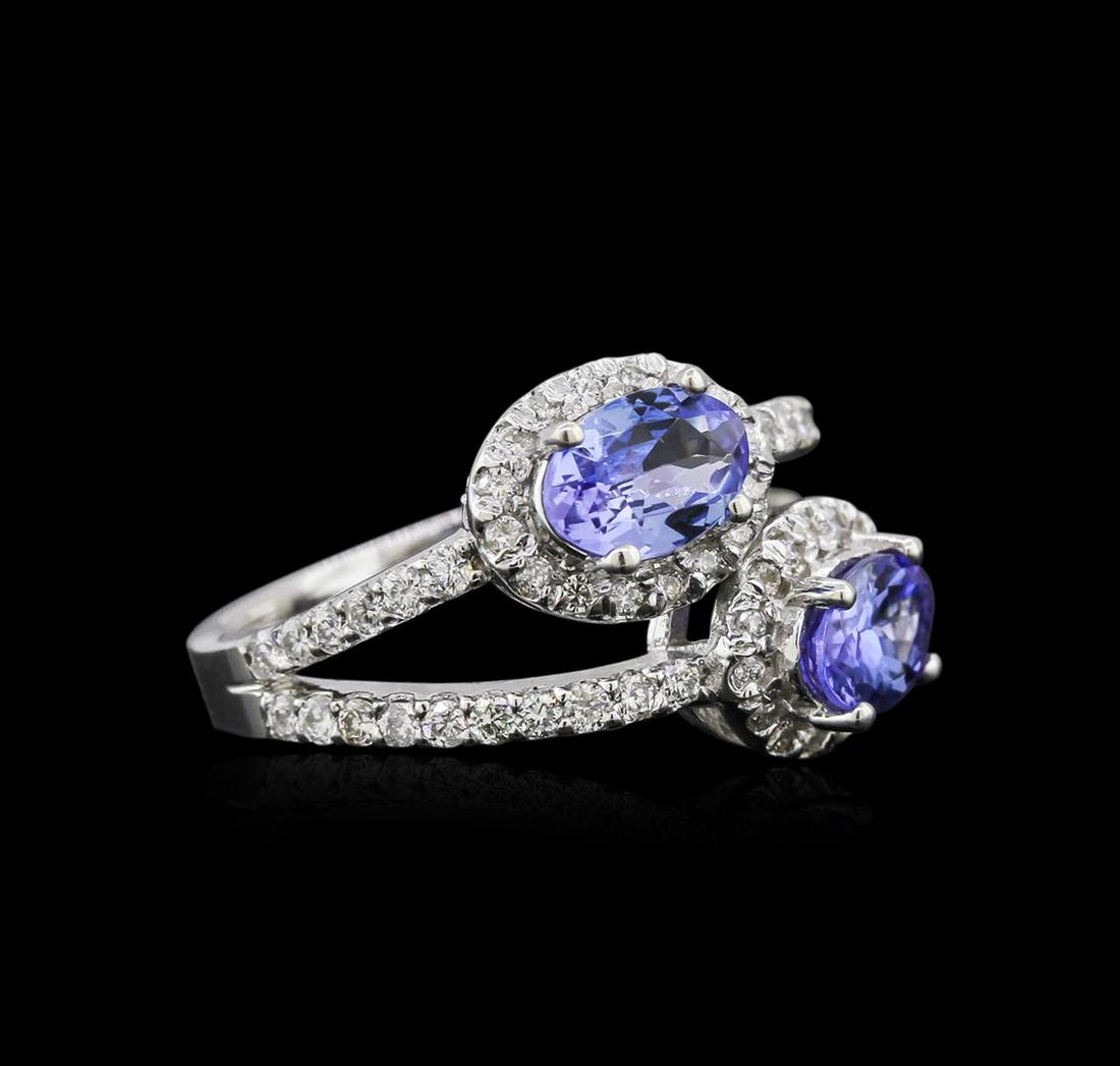 14KT White Gold 1.37 ctw Tanzanite and Diamond Ring: One electronically tested 14KT white gold ladies cast tanzanite and diamond ring with a split shoulder shank with a bright polish finish. Identified with markings of "K14". Condition is new. Containin