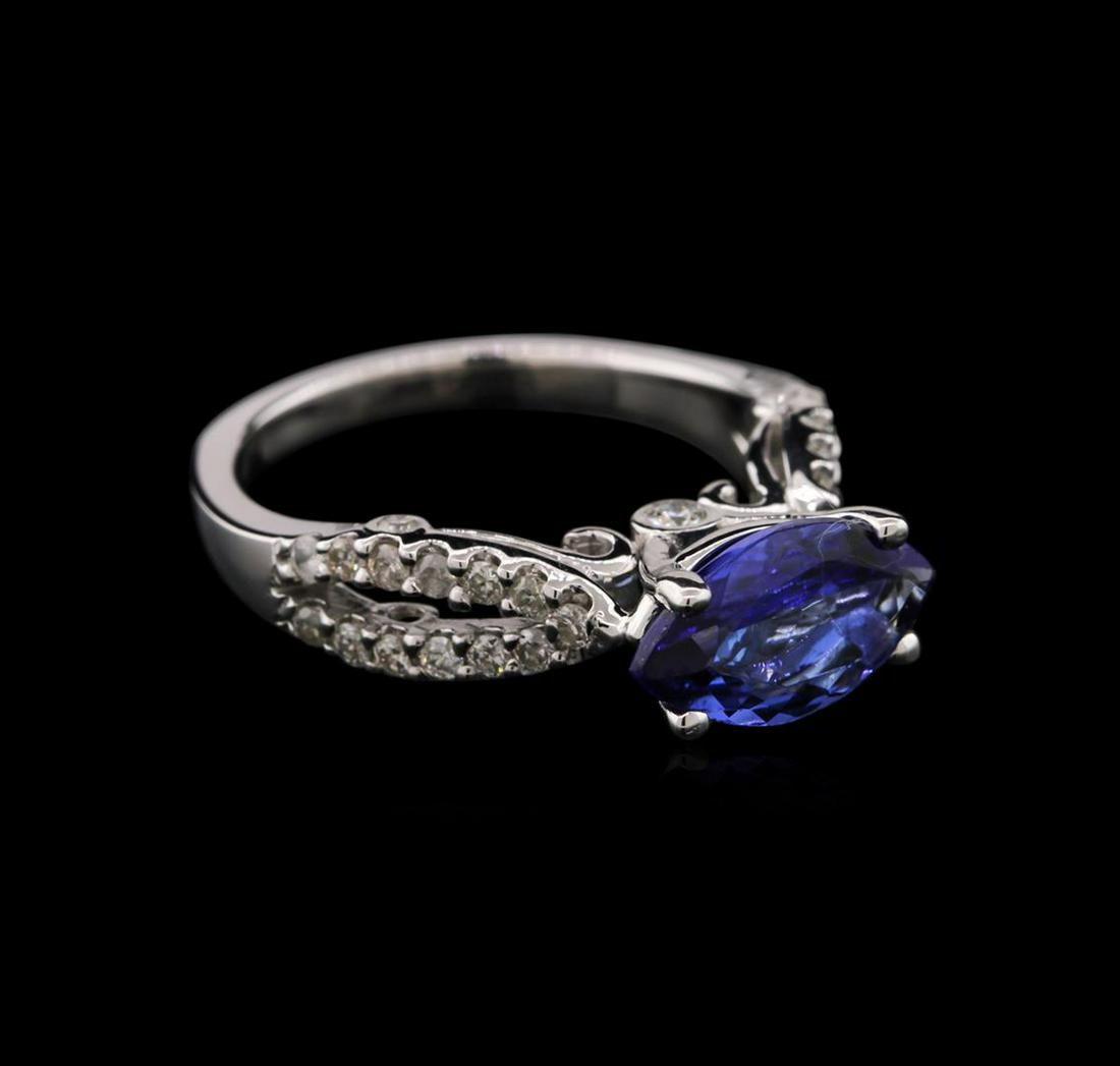 14KT White Gold 1.60 ctw Tanzanite and Diamond Ring: One electronically tested 14KT white gold ladies cast tanzanite and diamond ring with a bright polish finish. Identified with markings of "14K". Condition is new. Containing: One prong set marquise mo