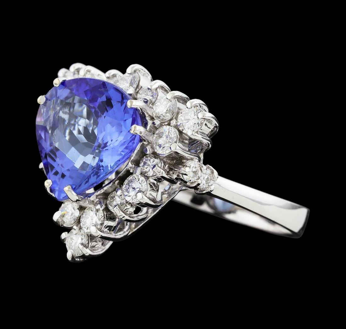 4.07 ctw Tanzanite and Diamond Ring - 14KT White Gold: One electronically tested 14KT white gold lady's cast fashion ring with a staggered basket halo with a bright polish finish. The featured lady's ring has a shank measuring 2.67 millimeters wide. Ident