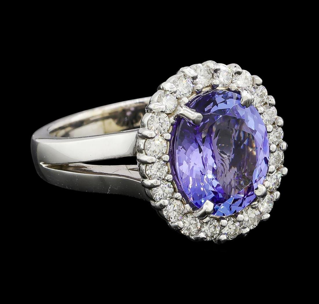 3.75 ctw Tanzanite and Diamond Ring - 14KT White Gold: One electronically tested 14KT white gold lady's cast fashion ring with a split shank basket halo with a bright polish finish. The featured lady's ring has a shank measuring 3.11 millimeters wide. Ide