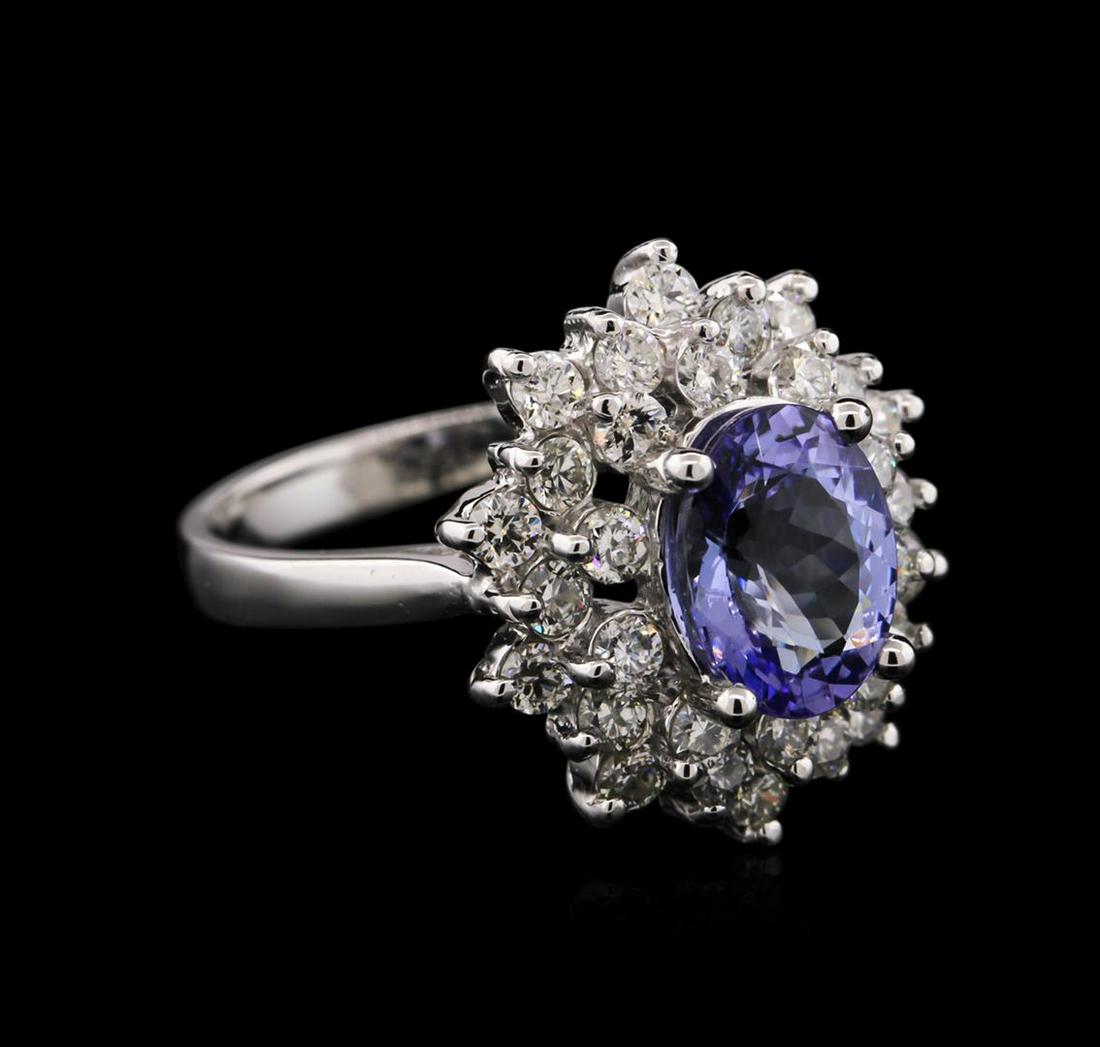 14KT White Gold 2.03 ctw Tanzanite and Diamond Ring: One electronically tested 14KT white gold ladies cast tanzanite and diamond ring with a bright polish finish. Identified with markings of "14K". Condition is new. Containing: One prong set oval modifi