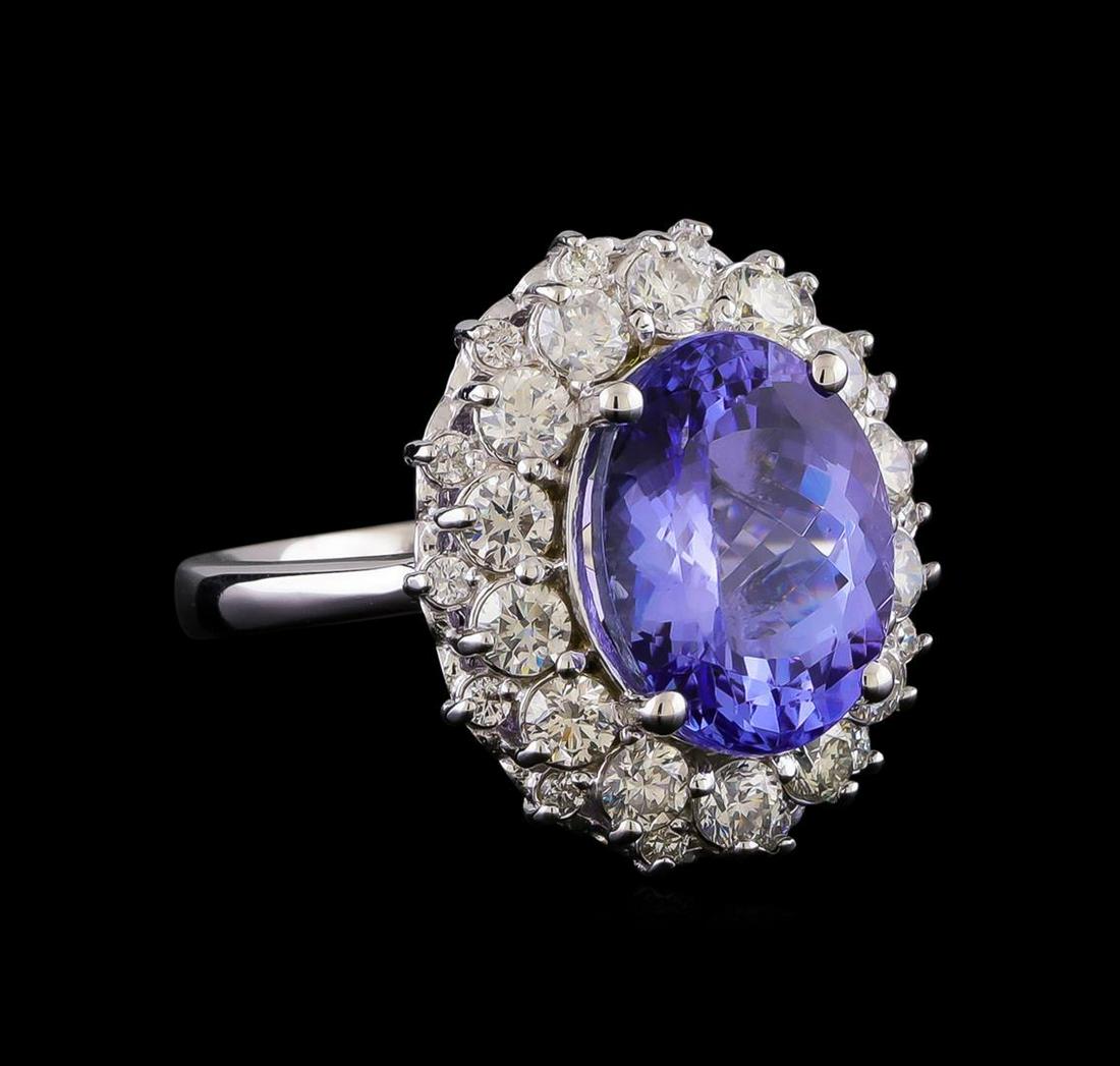 5.70 ctw Tanzanite and Diamond Ring - 14KT White Gold: One electronically tested 14KT white gold lady's cast fashion ring with a double basket halo with a bright polish finish. The featured lady's has a shank measuring 2.68 millimeters in width. Identifie