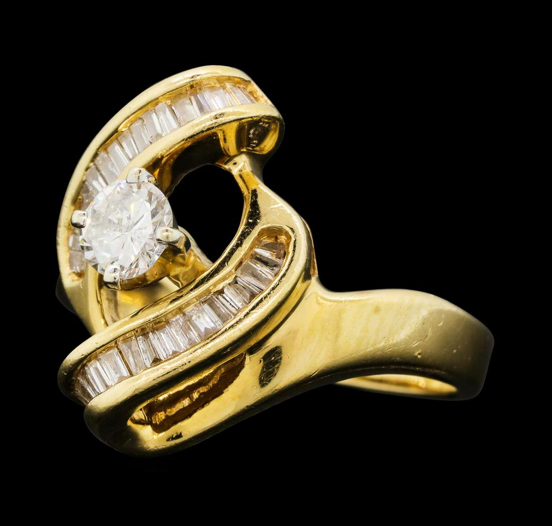0.69 ctw Diamond Ring - 14KT Yellow Gold: One electronically tested 14KT yellow gold lady's cast wedding ring with a bypass shank with a bright polish finish. The featured lady's ring has a shank measuring 2.75 millimeters wide. Identified wi