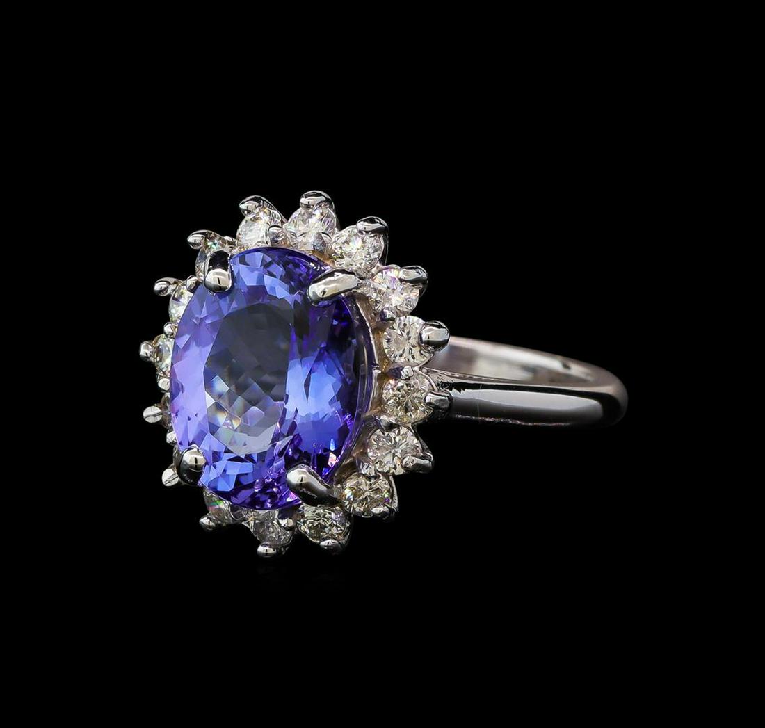 5.4 ctw Tanzanite and Diamond Ring - 14KT White Gold: One electronically tested 14KT white gold lady's cast fashion ring with a basket halo with a bright polish finish. The featured lady's ring has a shank measuring 2.12 millimeters wide. Identified with