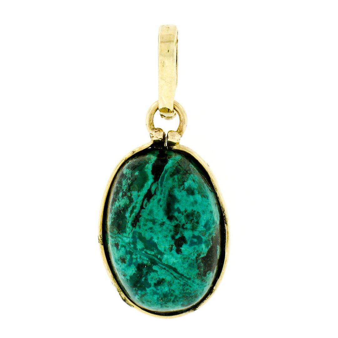 Vintage 14kt Yellow Gold Oval Cabochon Marbled Black &: A vintage 14kt yellow gold pendant featuring an oval cabochon cut marbled blue and black colored stone (13.6x9.7mm). The pendant weighs a total of 1.77 grams, measures 24.3x10.95mm including the bail,