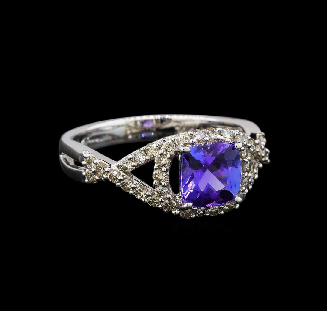 14KT White Gold 1.22 ctw Tanzanite and Diamond Ring: One electronically tested 14KT white gold ladies cast tanzanite and diamond ring with a bright polish finish. Identified with markings of "14K". Condition is new. Containing: One prong set square cush