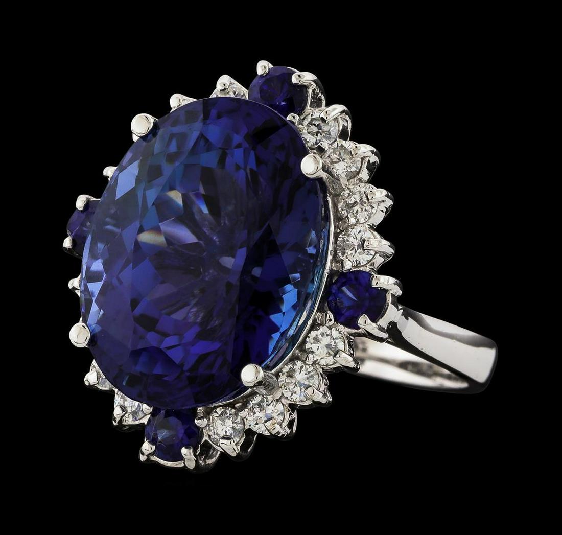 17.13 ctw Tanzanite, Sapphire and Diamond Ring - 14KT: One electronically tested 14KT white gold lady's cast fashion ring with a cathedral shank with a basket halo with a bright polish finish. The featured lady's ring has a shank measuring 2.90 millimeter