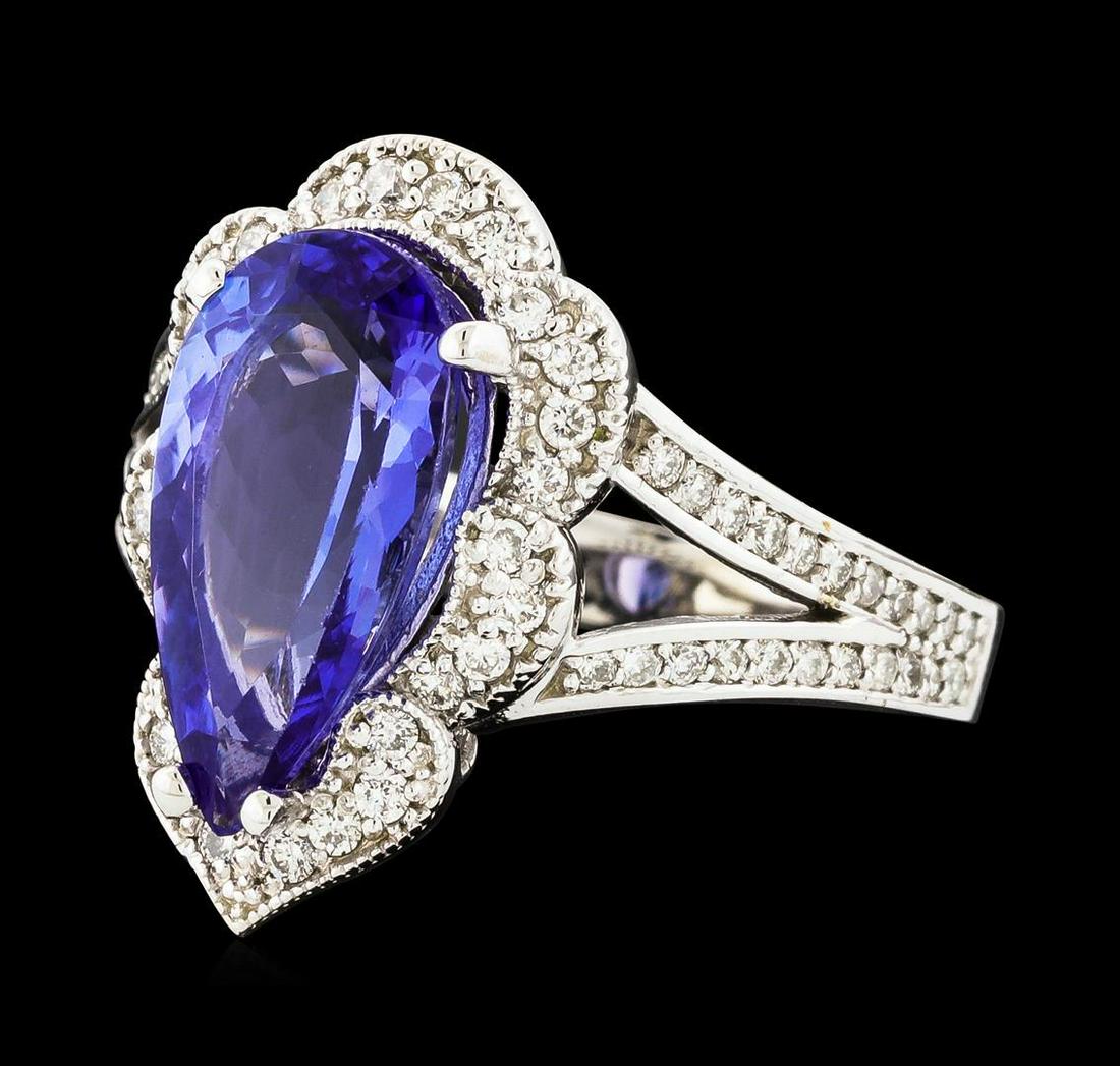 3.40 ctw Tanzanite and Diamond Ring - 14KT White Gold: One electronically tested 14KT white gold lady's cast fashion ring with a split shank scalloped basket halo with a bright polish with milgrain detailing finish. The featured lady's ring has a shank me