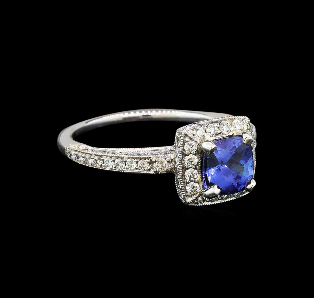 18KT White Gold 1.34 ctw Tanzanite and Diamond Ring: One electronically tested 18KT white gold ladies cast tanzanite and diamond ring with a bright polish finish. Identified with markings of "18K". Condition is new. Containing: One prong set oval square