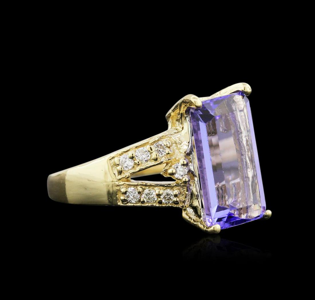 4.95 ctw Tanzanite and Diamond Ring - 14KT Yellow Gold: One ring featuring: 14KT yellow gold weighing 5.11 grams containing one tanzanite center stone with a total weight of 4.95ct and 14 diamonds with a total weight of 0.24ct.