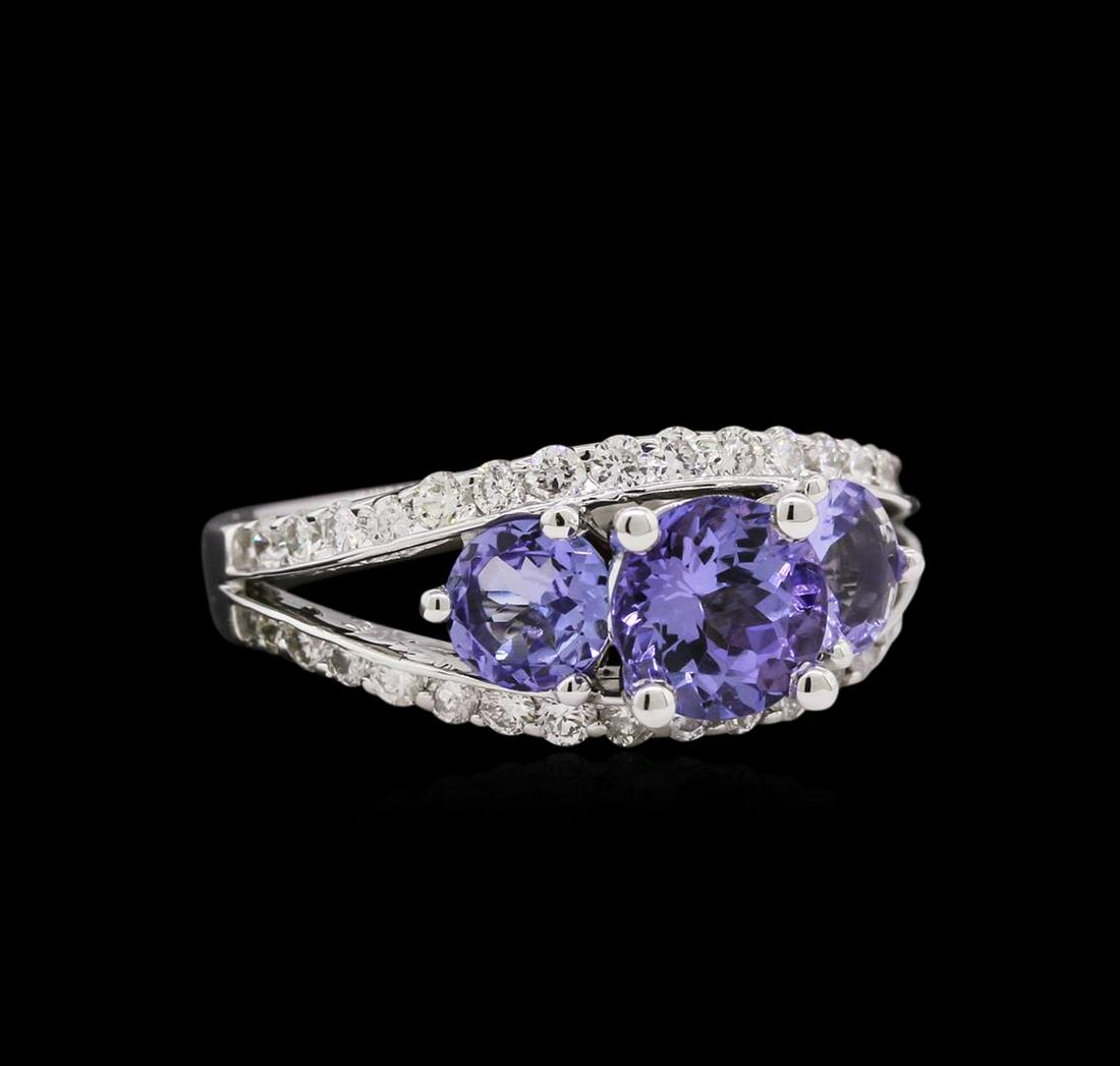 1.84 ctw Tanzanite and Diamond Ring - 14KT White Gold: One ring featuring: 14KT white gold weighing 5.35 grams containing 3 tanzanite with a total weight of 1.88ct and diamonds with a total weight of 0.69ct.