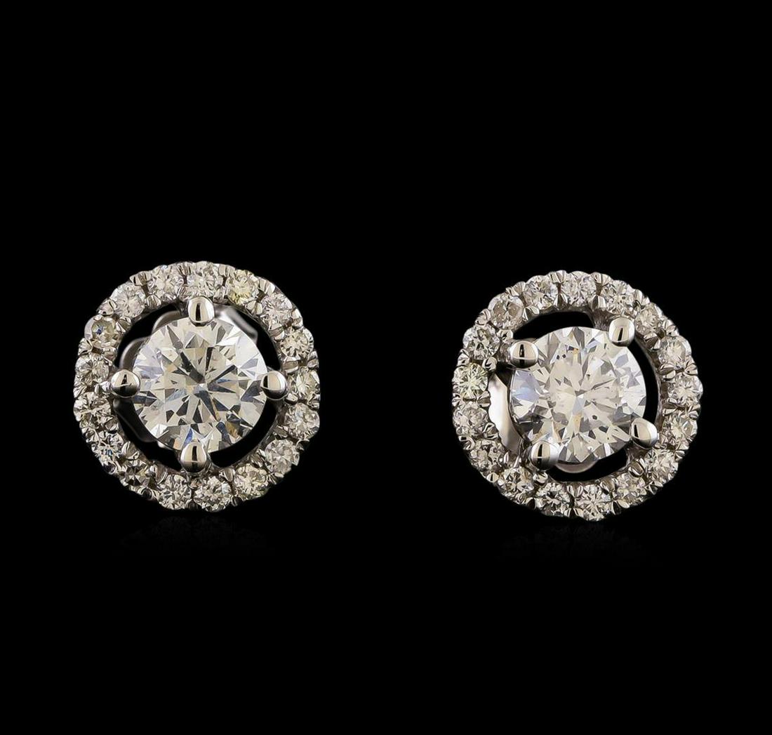 1.41 ctw Diamond Earrings - 14KT White Gold: One pair electronically tested 14KT white gold lady's cast stud earrings with friction posts with a halo with a bright polish finish. Identified with markings of '14K'. Condition is new, good workmans