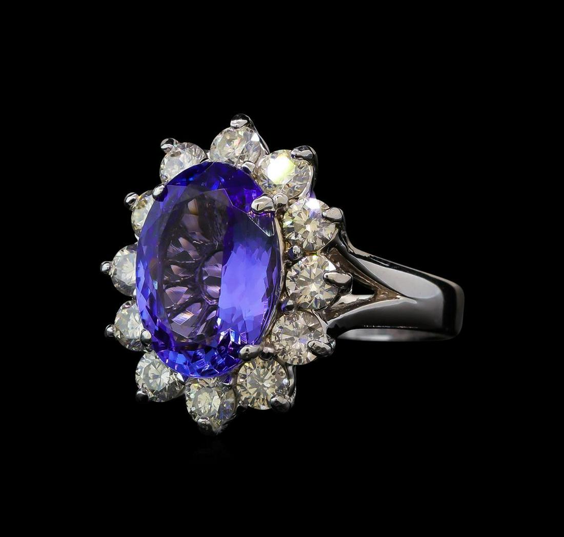 4.68 ctw Tanzanite and Diamond Ring - 14KT White Gold: One electronically tested 14KT white gold lady's cast fashion ring with a basket halo with a bright polish finish. The featured lady's ring has a shank measuring 2.82 millimeters wide. Identified with