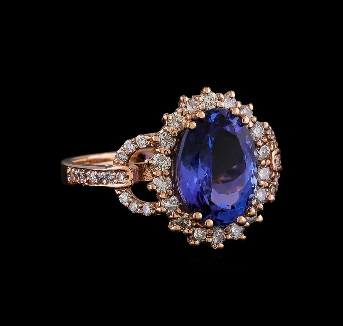 3.93 ctw Tanzanite and Diamond Ring - 14KT Rose Gold: One electronically tested 14KT rose gold lady's cast fashion ring with a cathedral basket halo with a bright polish finish. The featured lady's has a shank measuring 2.05 millimeters in width. Identif