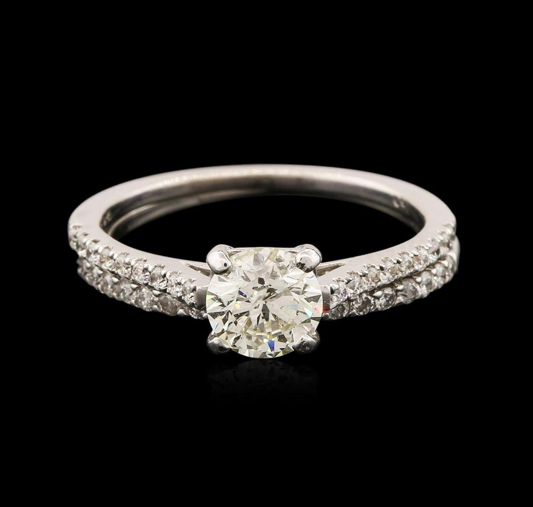 14-18KT White Gold 1.08 ctw Diamond Wedding Ring Set: One electronically tested 18KT and 14KT white gold ladies cast diamond wedding set. The wedding set consists of a diamond engagement ring and a diamond wedding band. The 18KT white gold engagement fea