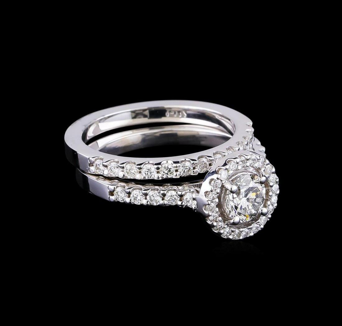 1.23 ctw Diamond Wedding Ring Set - 14KT White Gold: One electronically tested 14KT white gold lady's cast wedding set rings with a halo with a bright polish finish. The featured lady's ring set has a double shank measuring 4.11 millimeters in width. Id