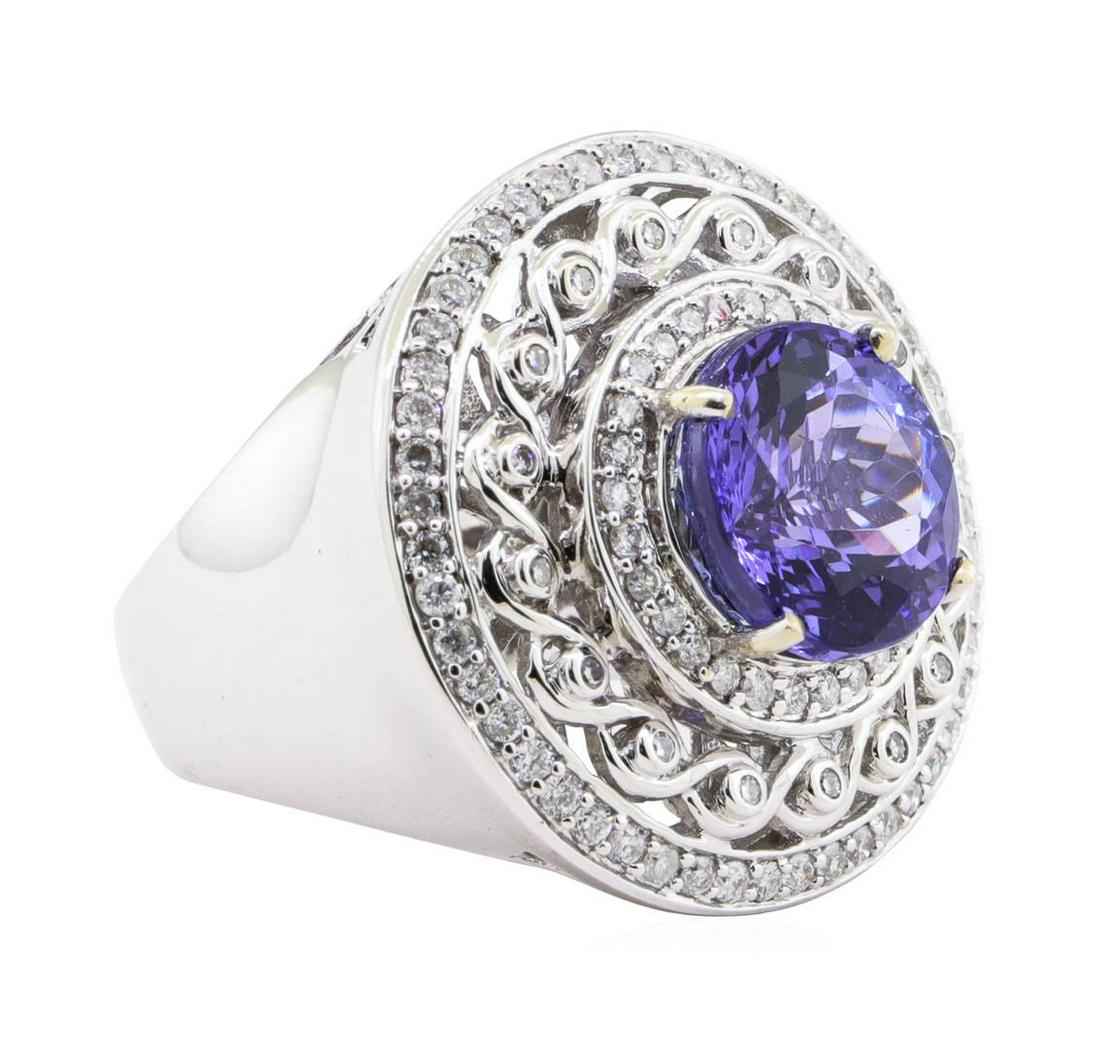 6.94 ctw Tanzanite and Diamond Ring - 14KT White Gold: One electronically tested 14KT white gold ladies cast tanzanite & diamond ring with a bright finish. The featured tanzanite is set within three unique diamond bezels, supported by an elaborate white g