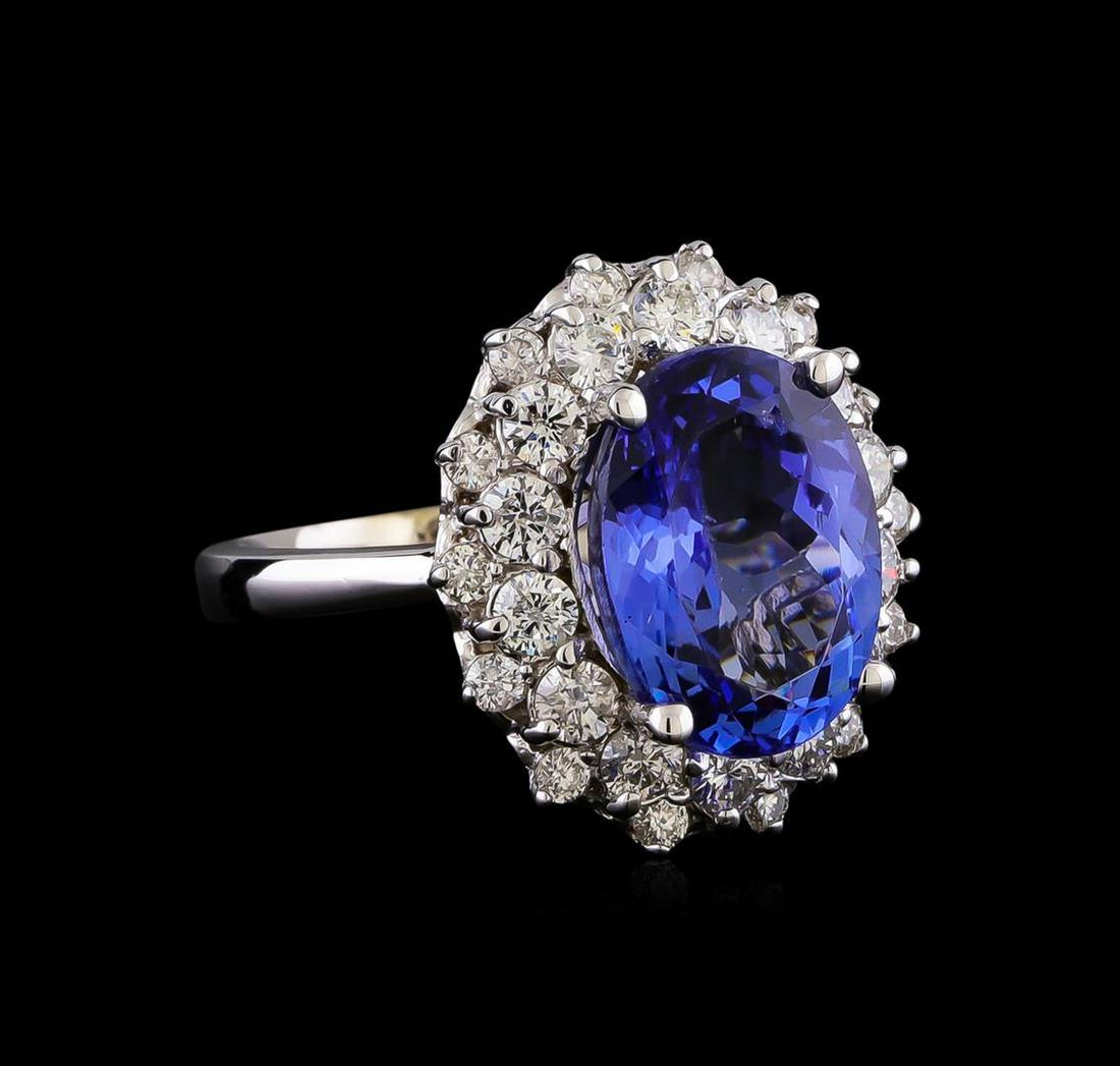 5.53 ctw Tanzanite and Diamond Ring - 14KT White Gold: One electronically tested 14KT white gold lady's cast fashion ring with a double basket halo with a bright polish finish. The featured lady's has a shank measuring 2.58 millimeters in width. Identifie